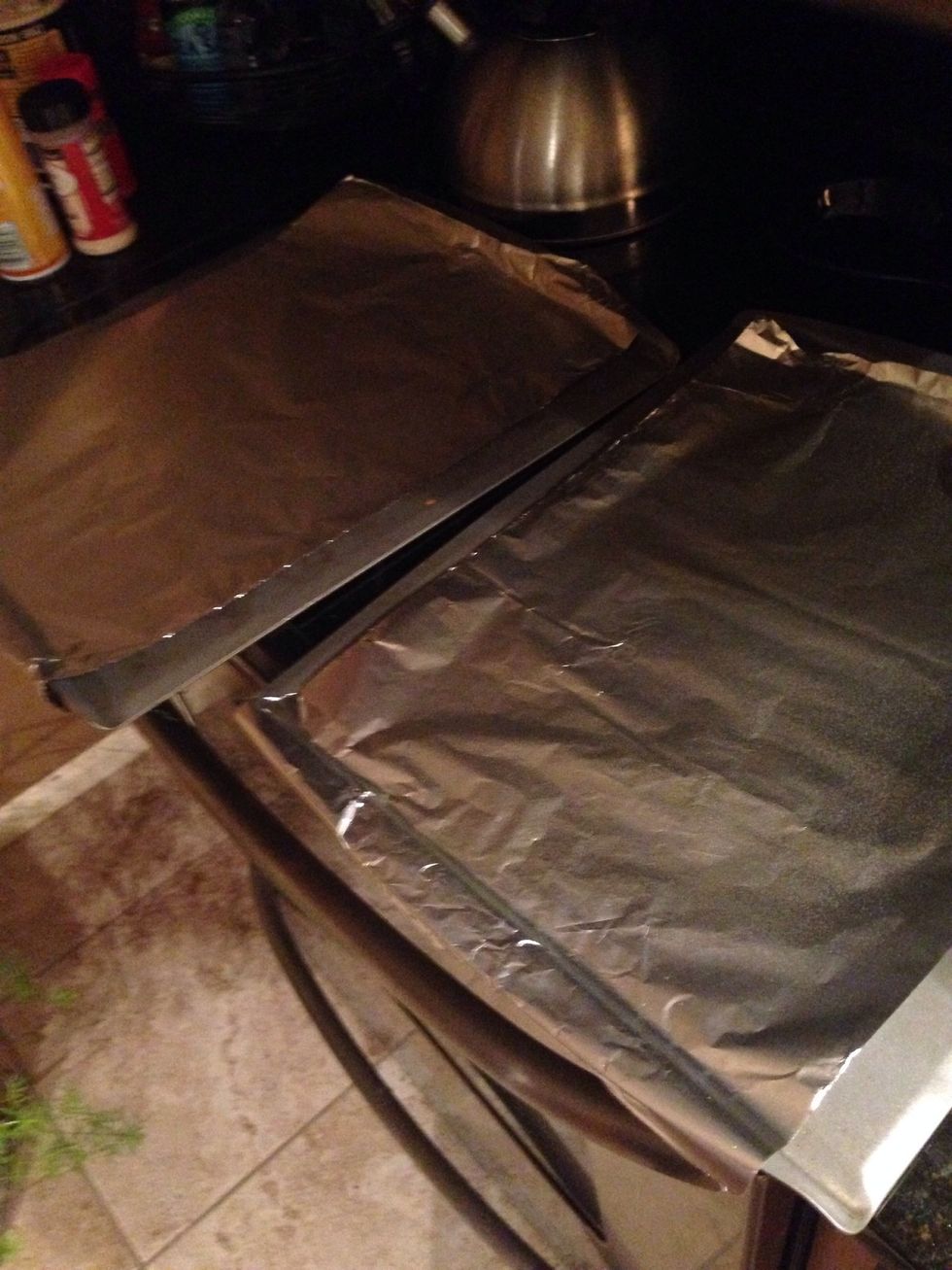 Cover two cookie sheets with aluminum foil and spray with cooking spray.