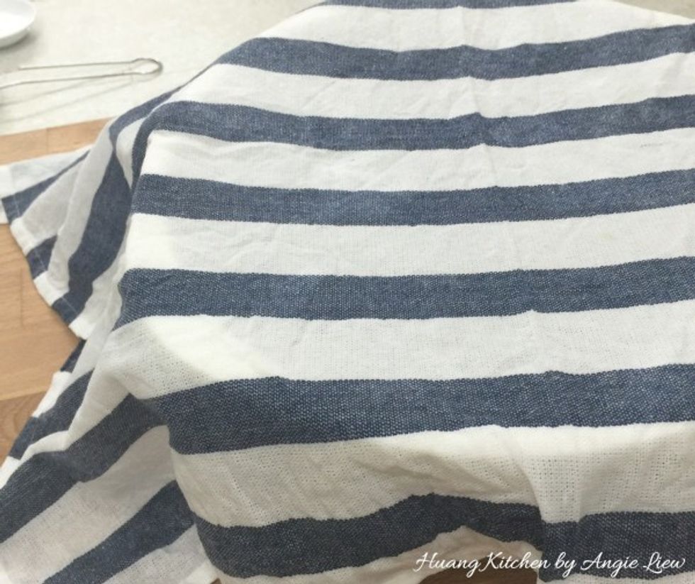 Cover with a piece of damp kitchen towel and leave the dough to rise until double in size, about 30 to 40 minutes.
