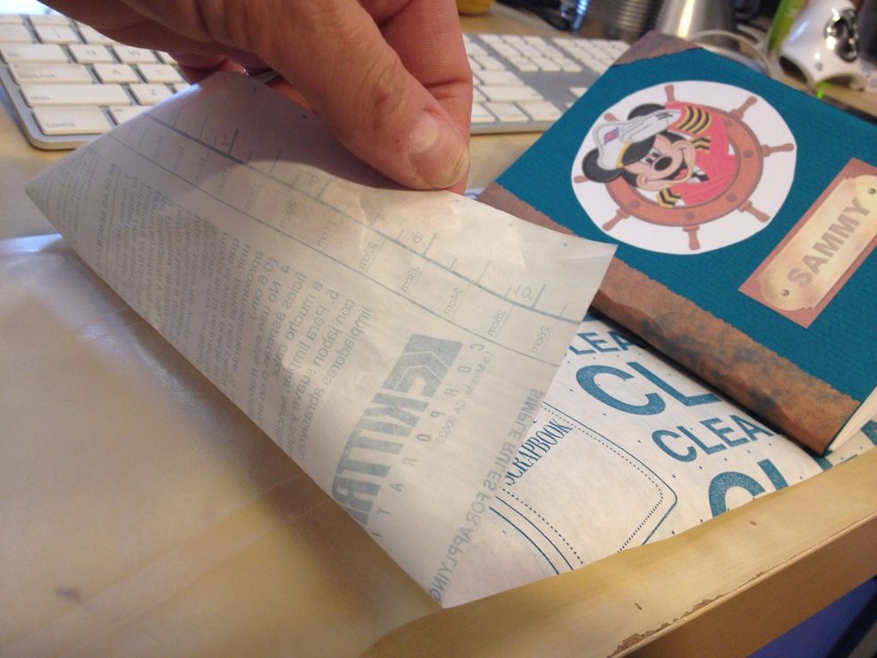 Cover with clear con-tac paper. This is optional but adds durability. Cut a piece that measures 4 x the book's width long, and an inch or two taller than the book's height. Peel off the backing.