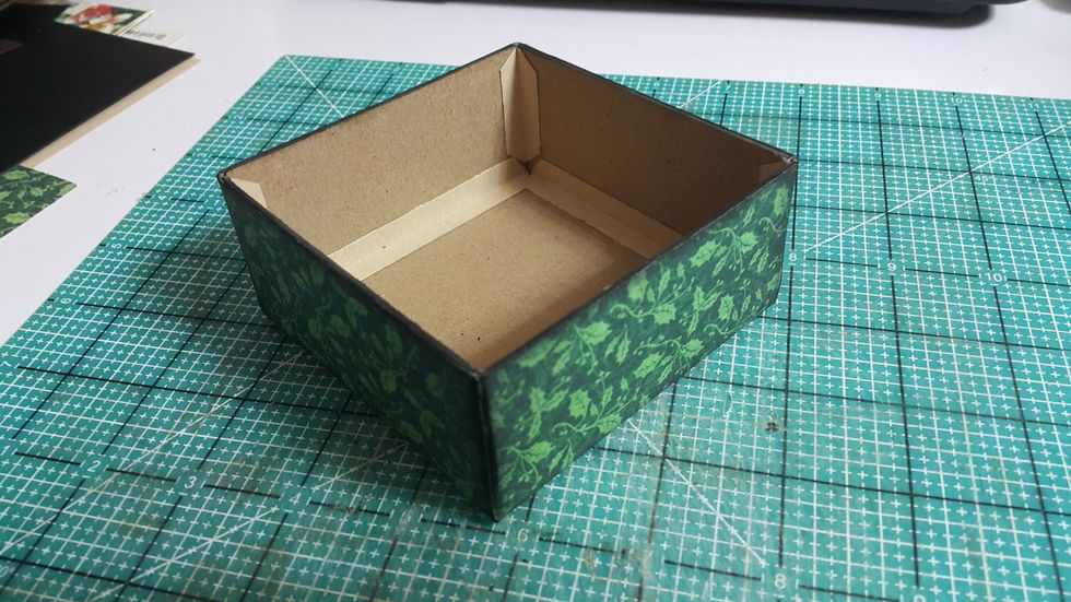 Cover with pattern paper, you can spread some bricks pattern with molding paste like the what we did on the window shadow box