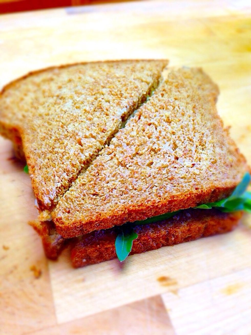 Cover with the remaining slice of bread and cut diagonally