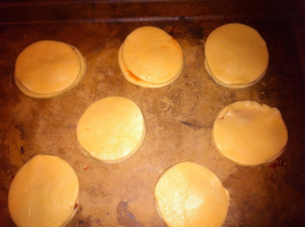 Cover with top dough, brush with egg wash. Take a fork and pinch the sides all around. Push fork into top a few times to make holes for the steam to escape.