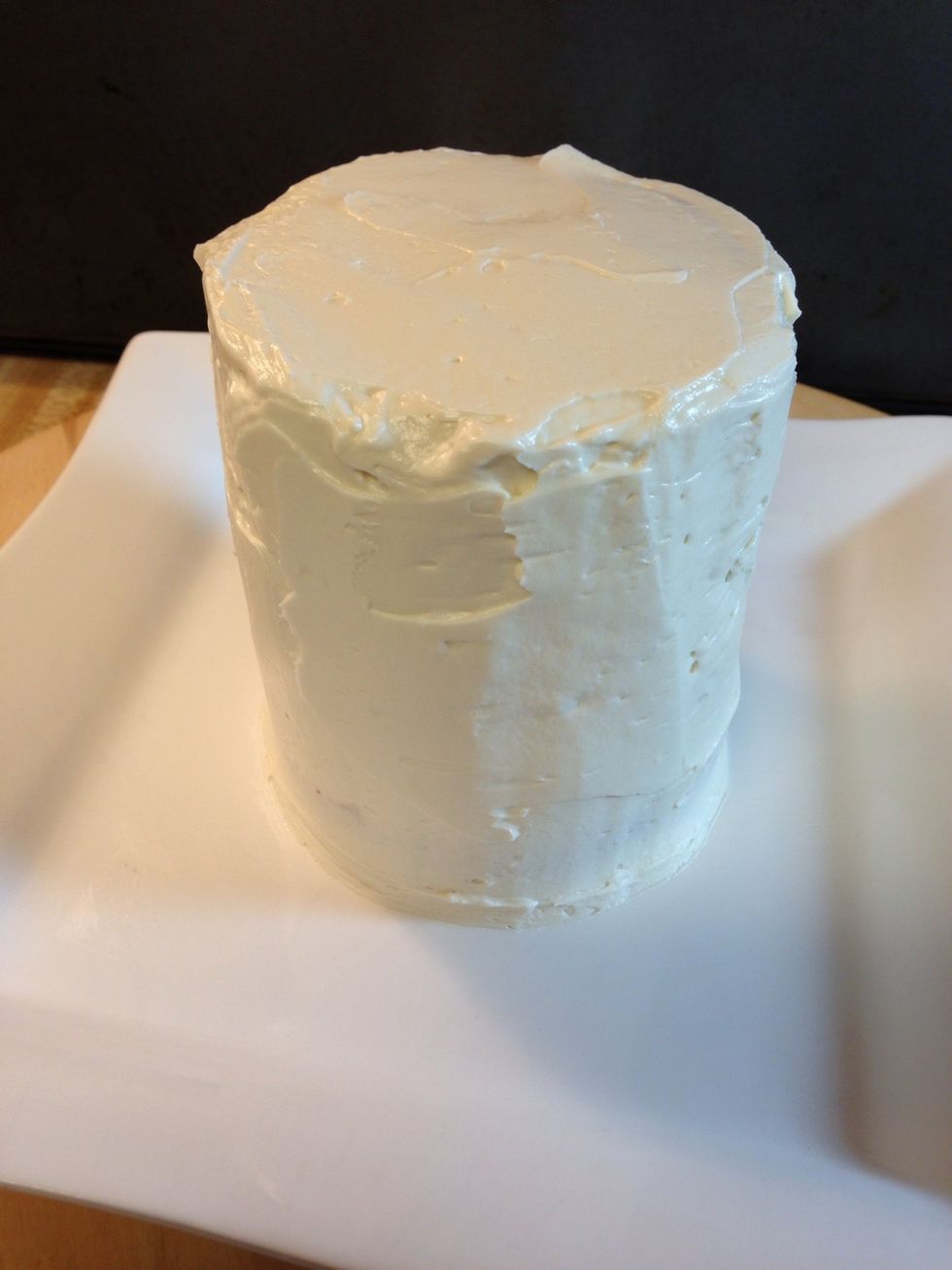 Cover your cake with a generous amount of frosting. It doesn't have to be neat because we will be covering it with cookies.