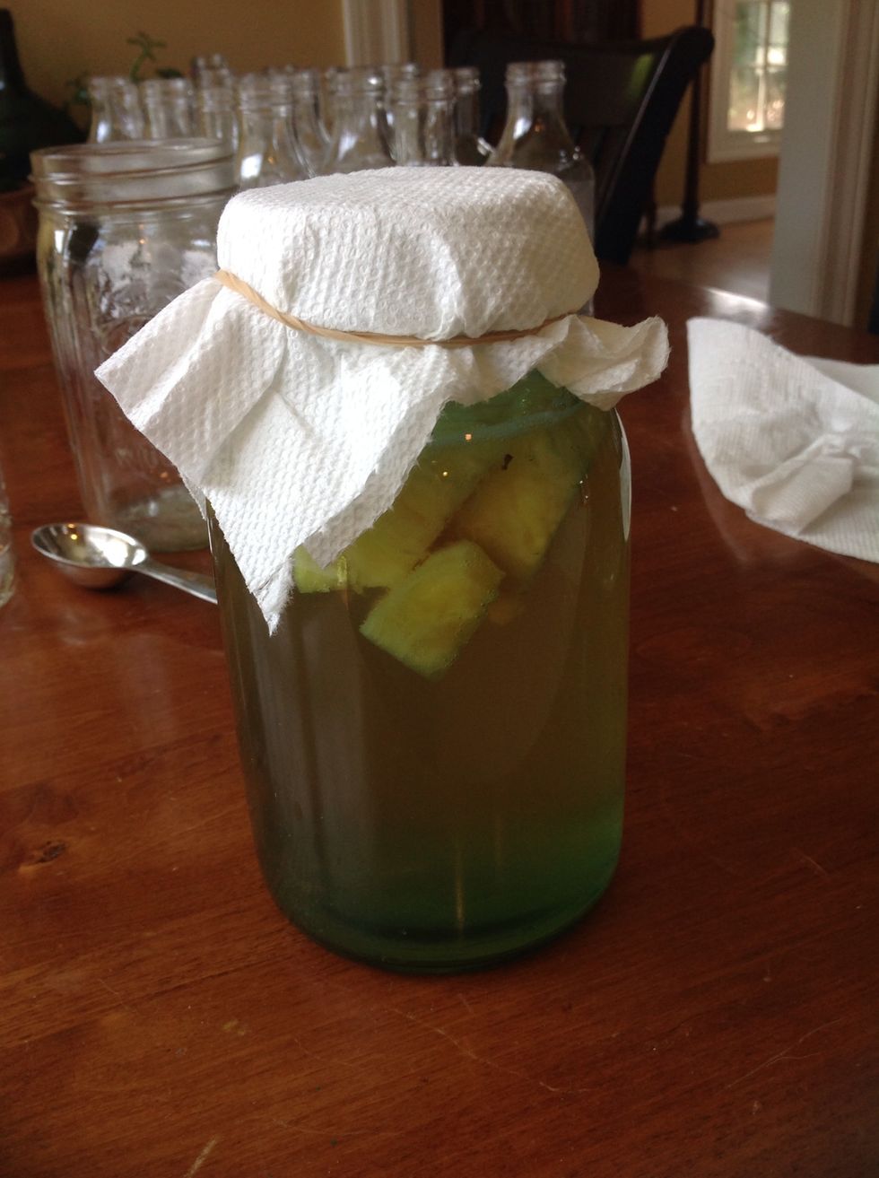 Cover your kombucha for 4-7 days and put in a warm place until the desired fermentation is reached. This is the stage where the fizziness is added. Remove fruit and pour into bottles.