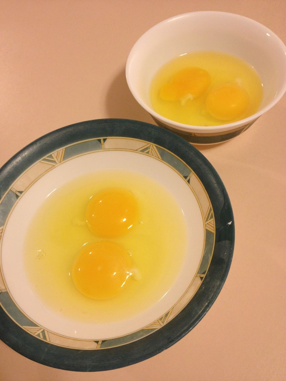 Crack 2 eggs into a small bowl and the other 2 eggs into another bowl. Use a slotted spoon to scoop the yolks from one bowl into the other. Save the bowl of egg whites for tomorrow's breakfast!