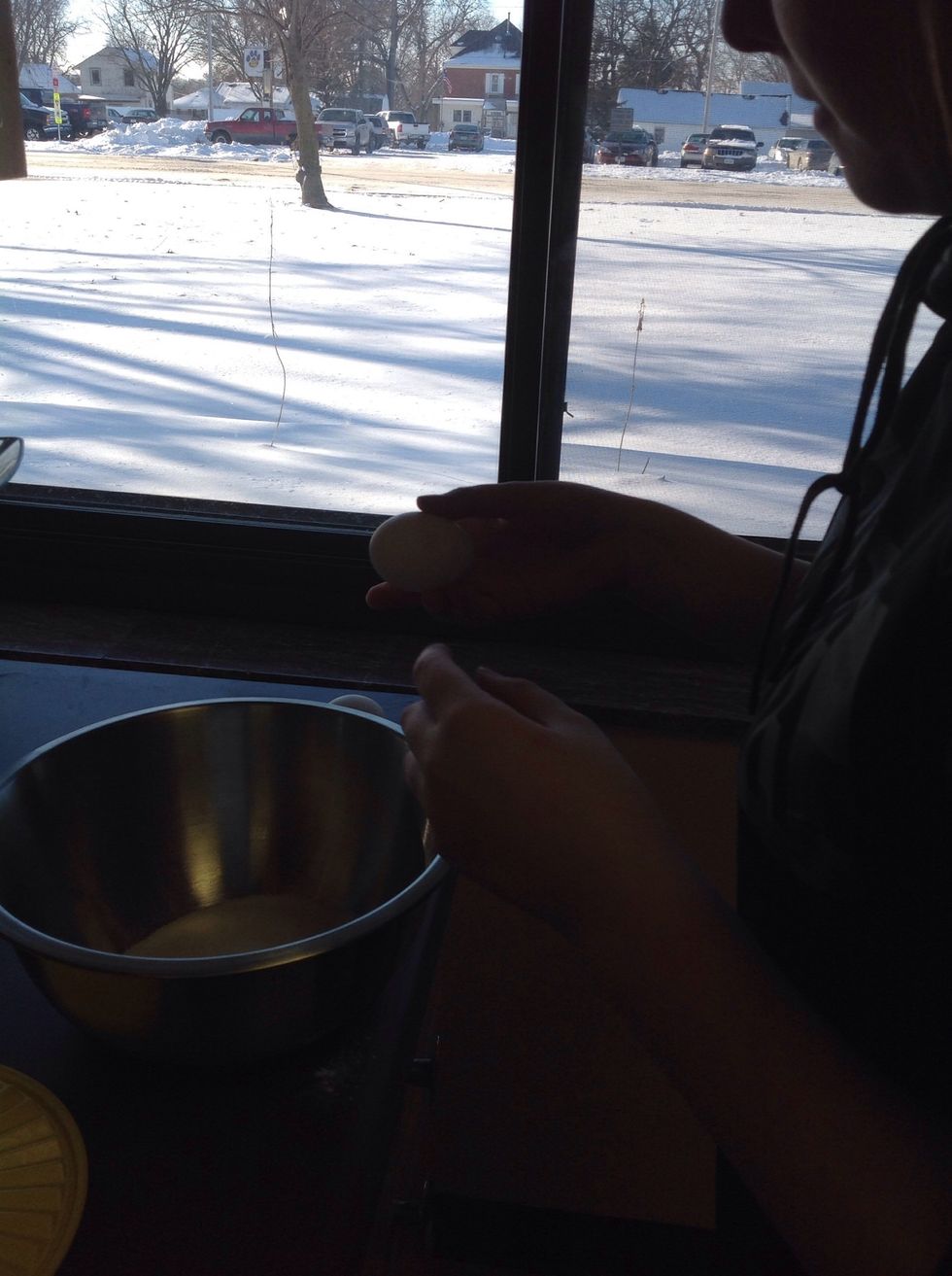 Crack 2 eggs into sugar