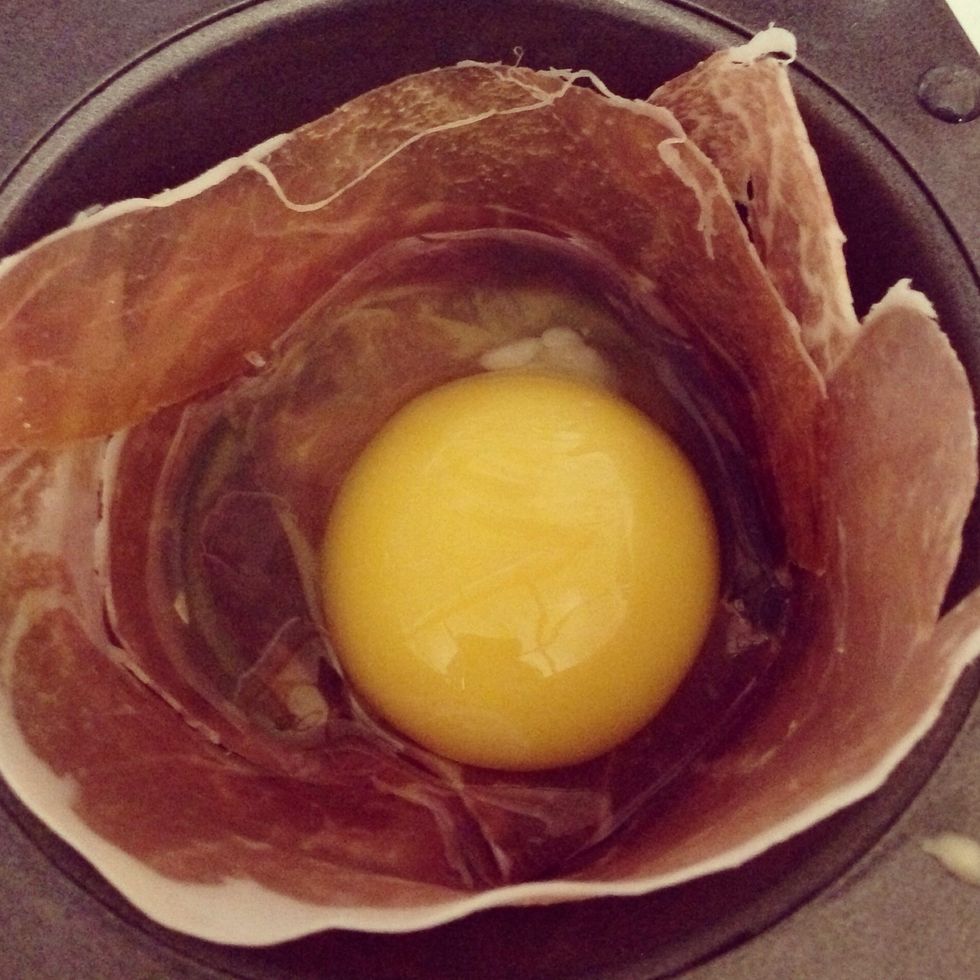 Crack a single egg into each prosciutto or bacon bowl.