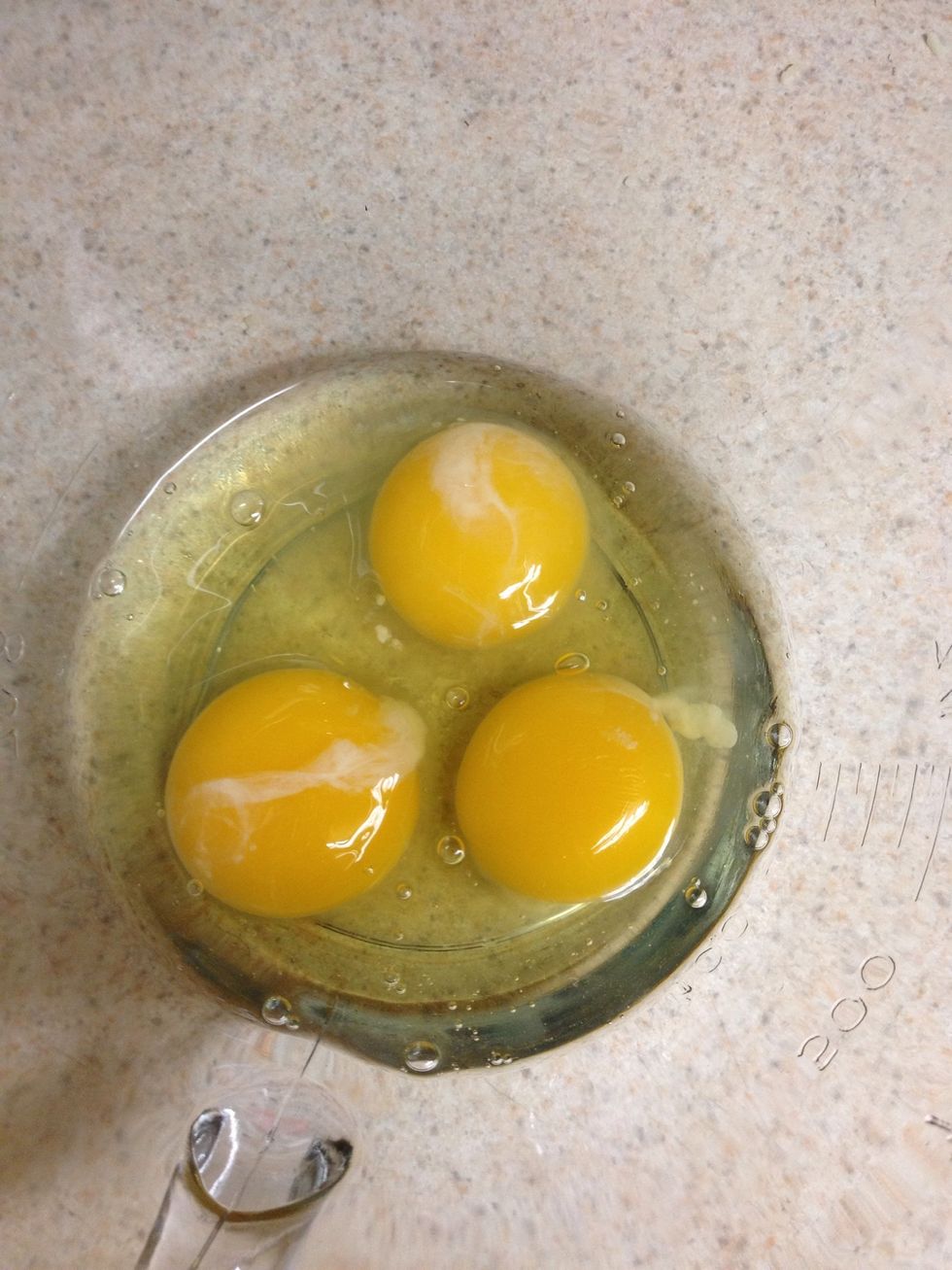 Crack, add salt, pepper, and milk to eggs
