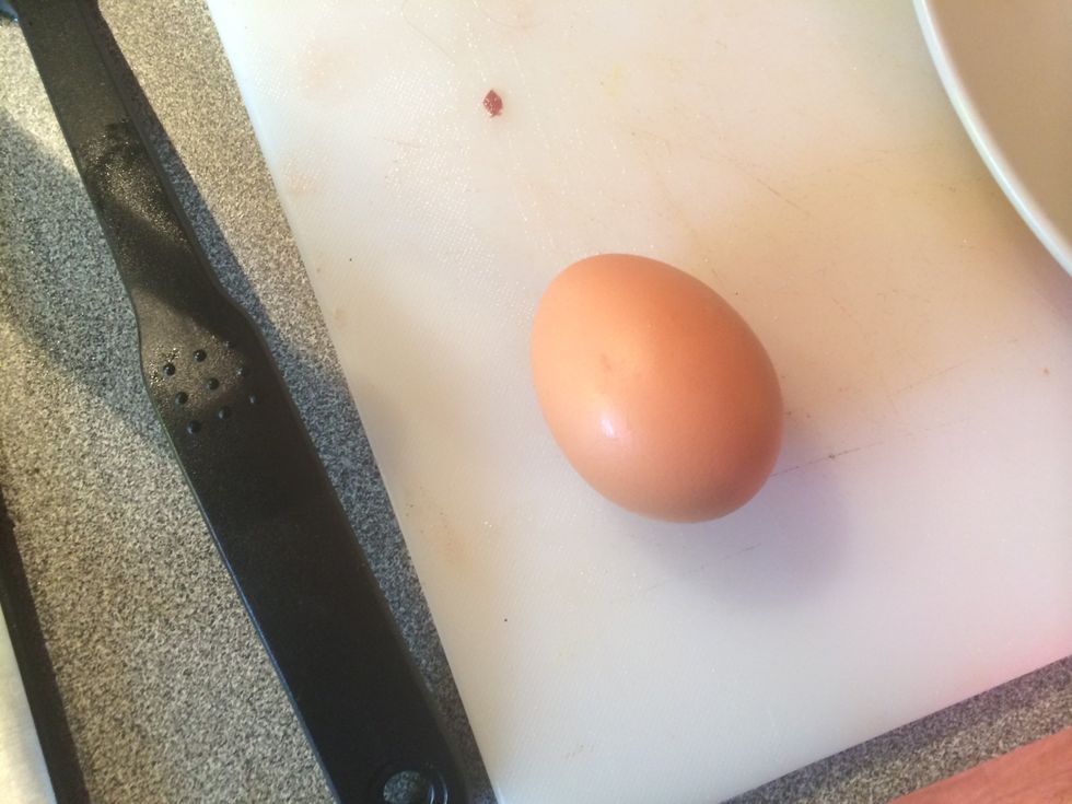 Crack an egg on a flat surface. This will less likely break the yolk.