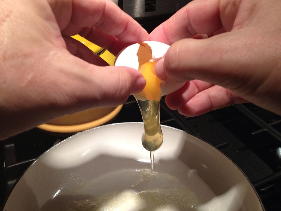 Crack both eggs above the pan ,make sure not not to get any egg shells in the pan
