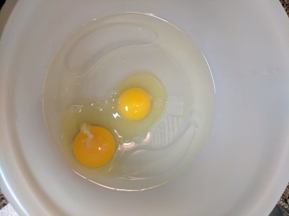 Crack both eggs and pour the whites and yolks into the mixing bowl.