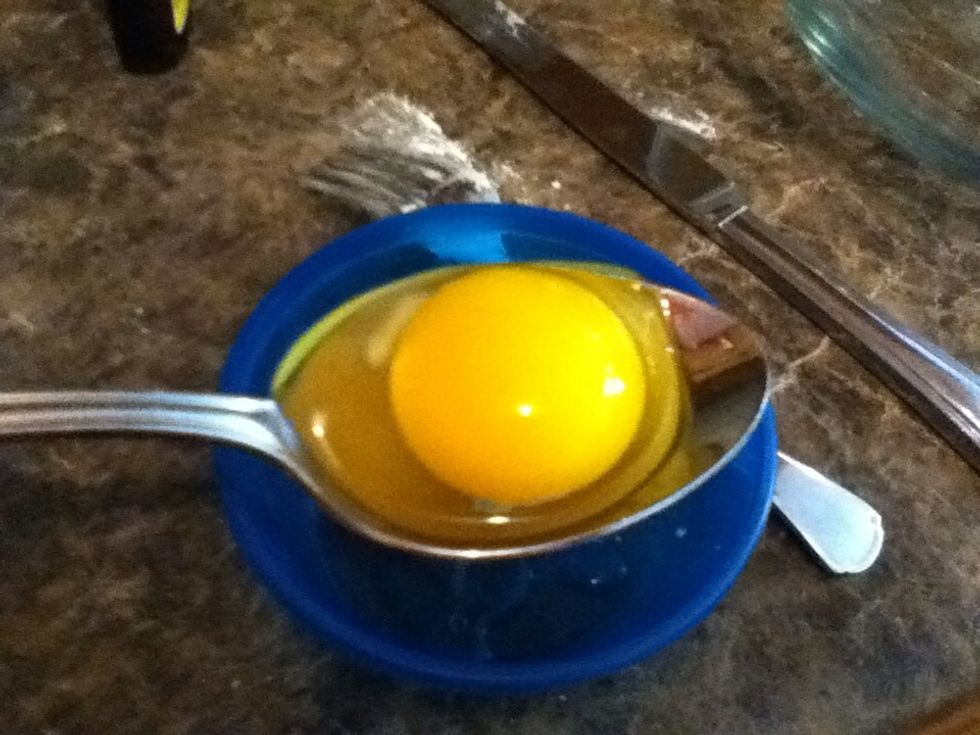 Crack egg into slotted spoon. Gently slide the egg back and forth if the white is clinging to the yolk.