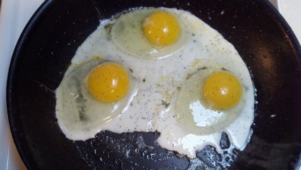 Crack eggs into pan, salt & pepper to taste, and allow butter to sizzle while eggs cook - About five minutes.