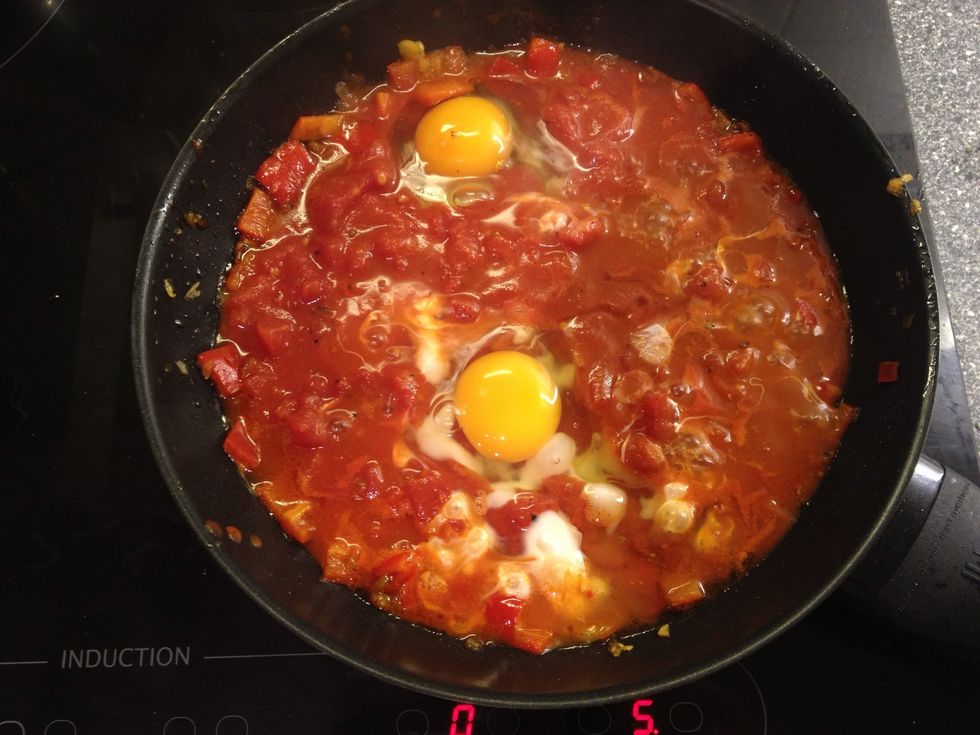 Crack open the eggs about half a foot above the sauce so they sink a bit into it.