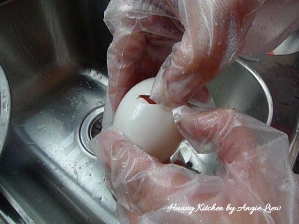 Crack the cleaned salted egg to remove the yolk. Repeat the same with the rest of the eggs.