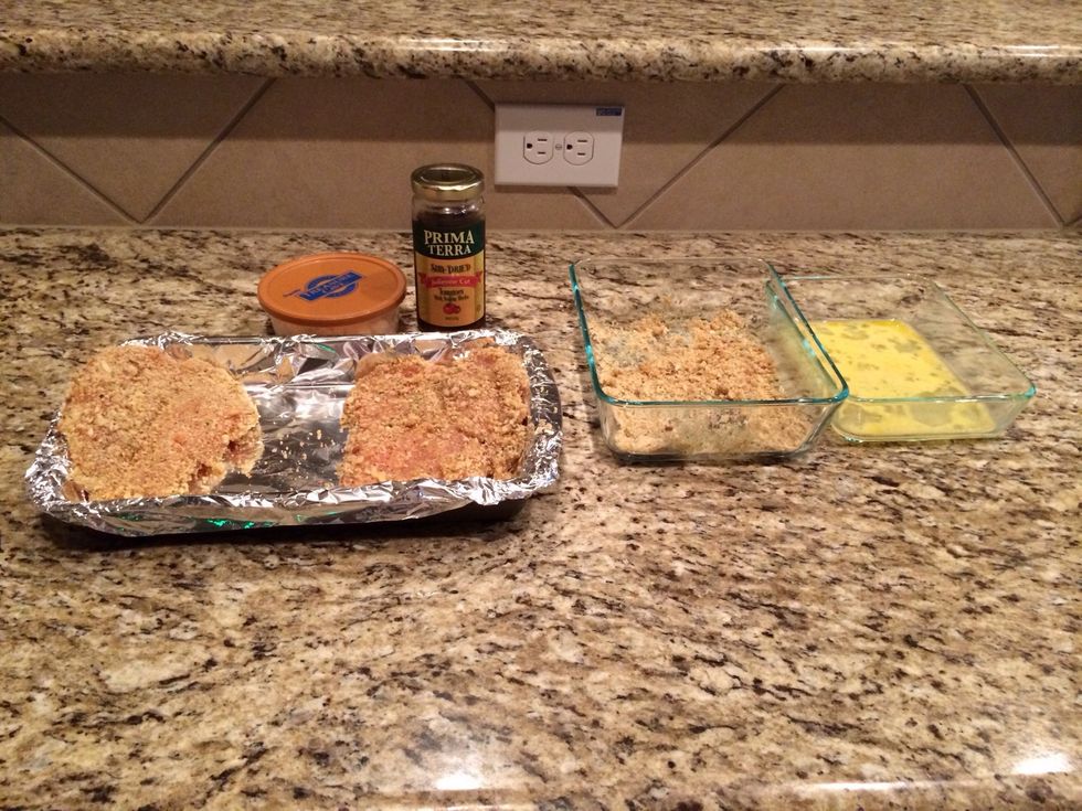 Crack the egg and mix it up to coat your chicken, crush the stovetop into a nice breading texture. Clean all the fat from the chicken and butterfly it. Dip in egg and then into stovetop.