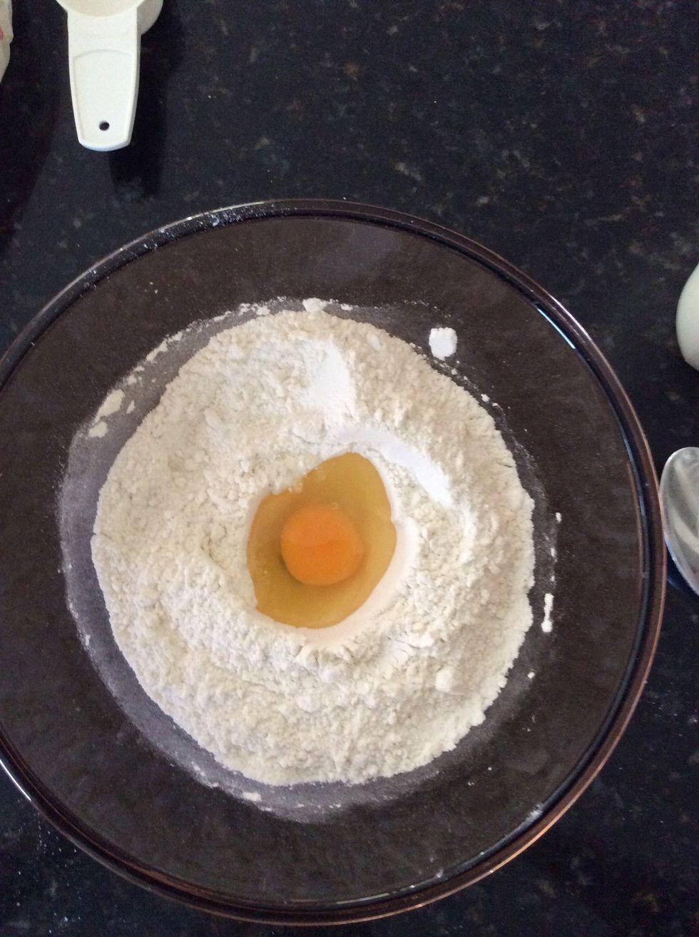 Crack the egg on the side of the mixing bowl and gently place the egg whites and yolk into the centre of the hole.