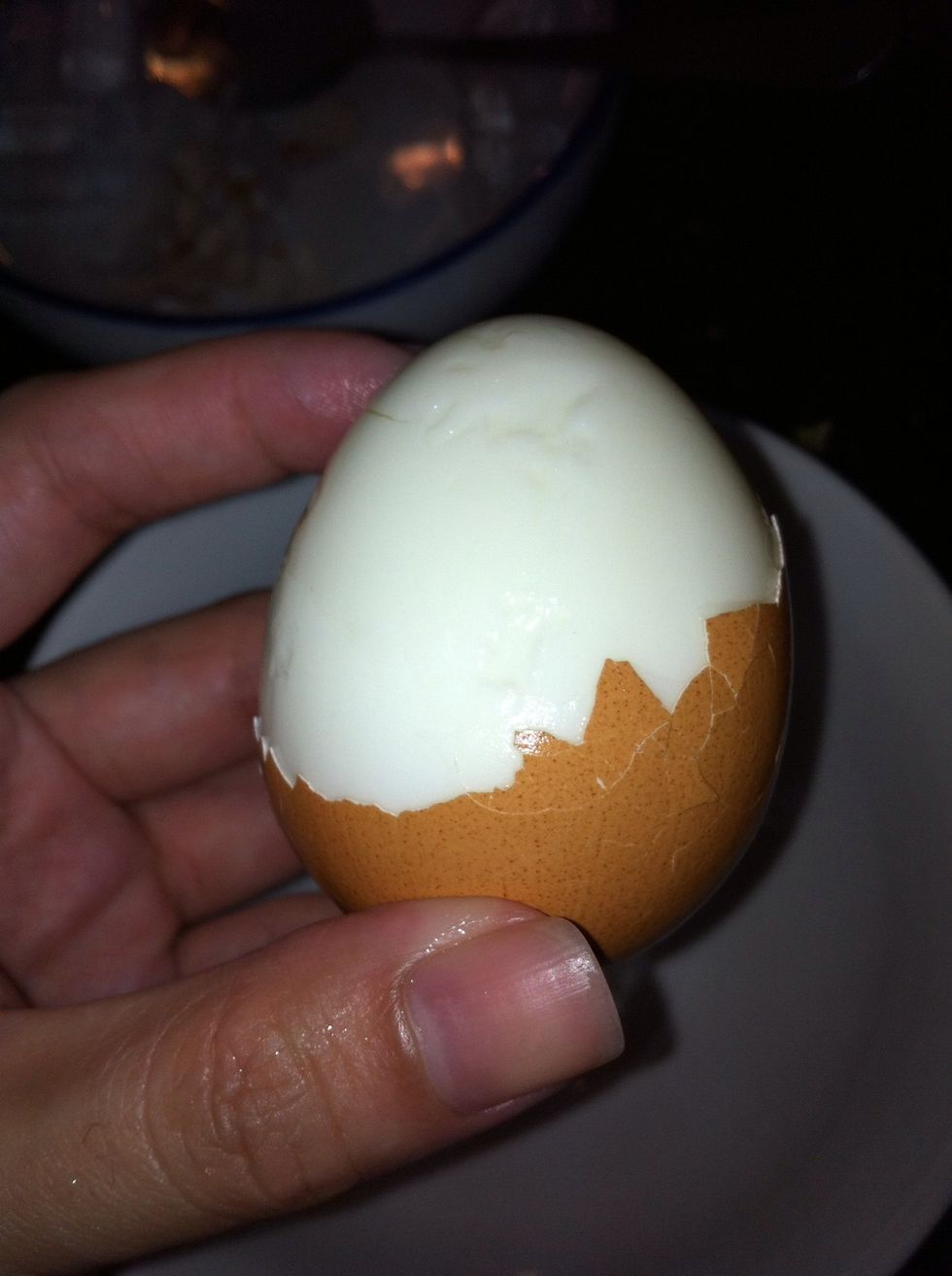 Crack the egg shell and peel off the shell..