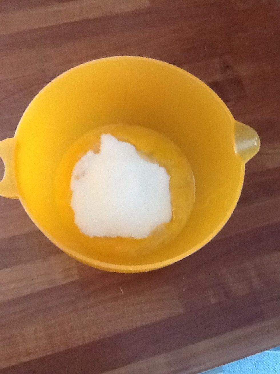 Crack the eggs and pour the sugar into a bowl.