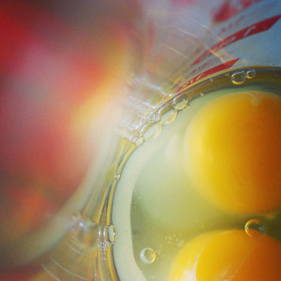 Crack the eggs into a bowl. Try not to break the yolks!