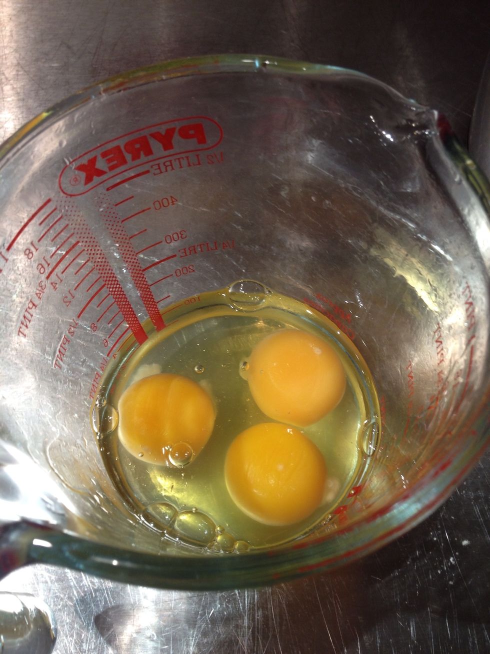 Crack the eggs into a jug.