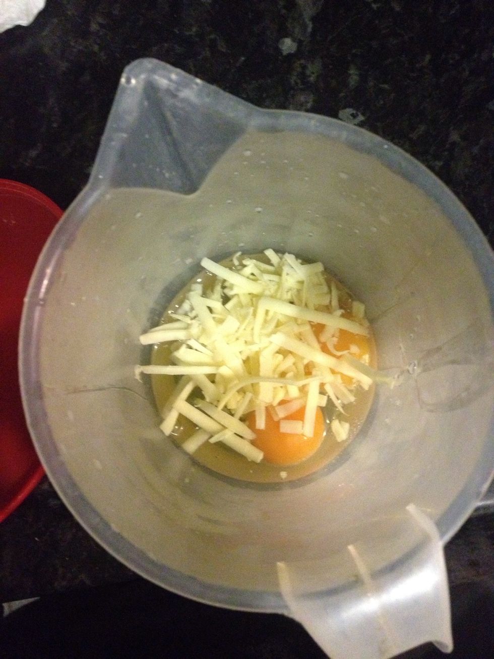 crack the eggs into a microwave proof jug and add cheese