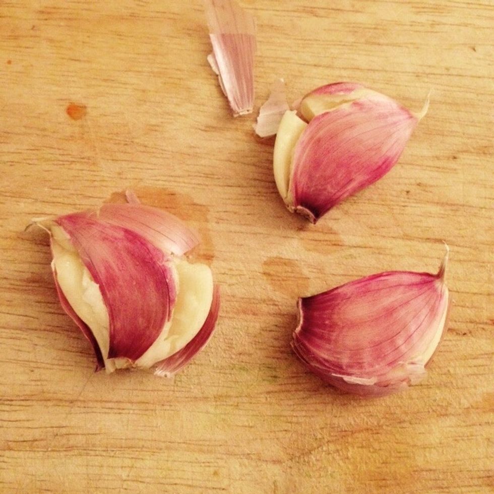 Crack the garlic cloves