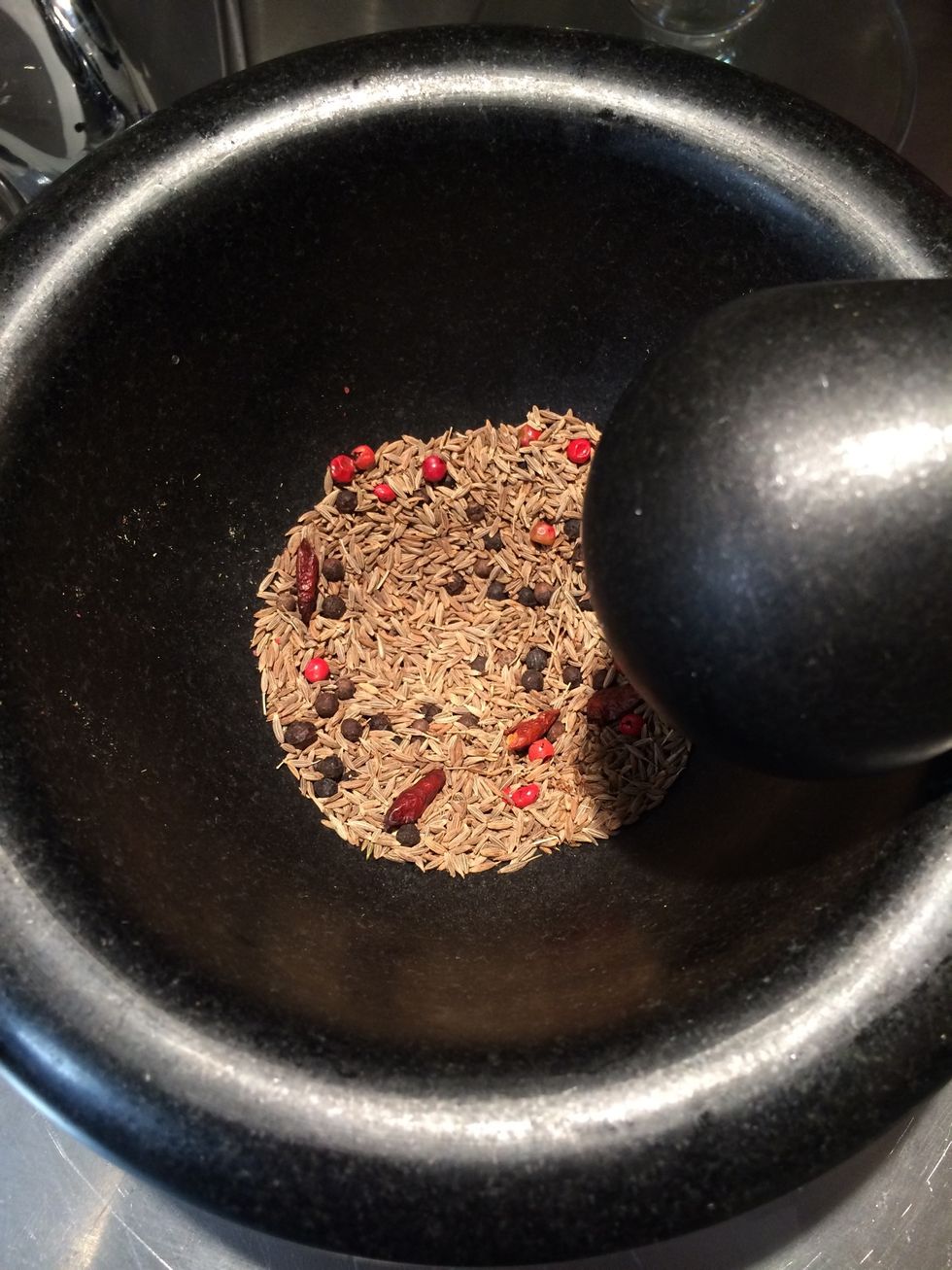 Crack the spices(don't grind them) add to the oil. Put over the sliced potatoes and coat them well