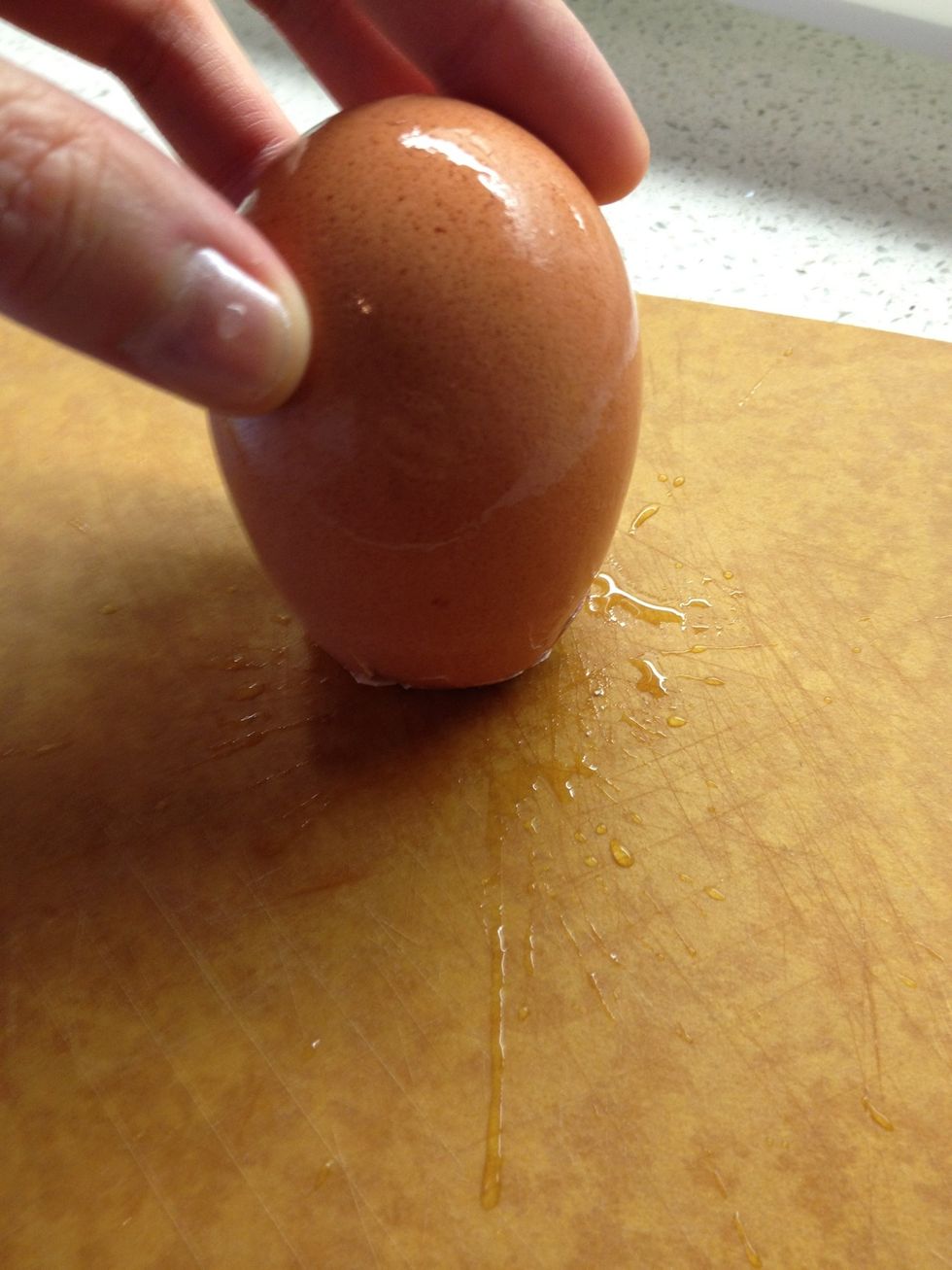 Crack the top or bottom of the shell.