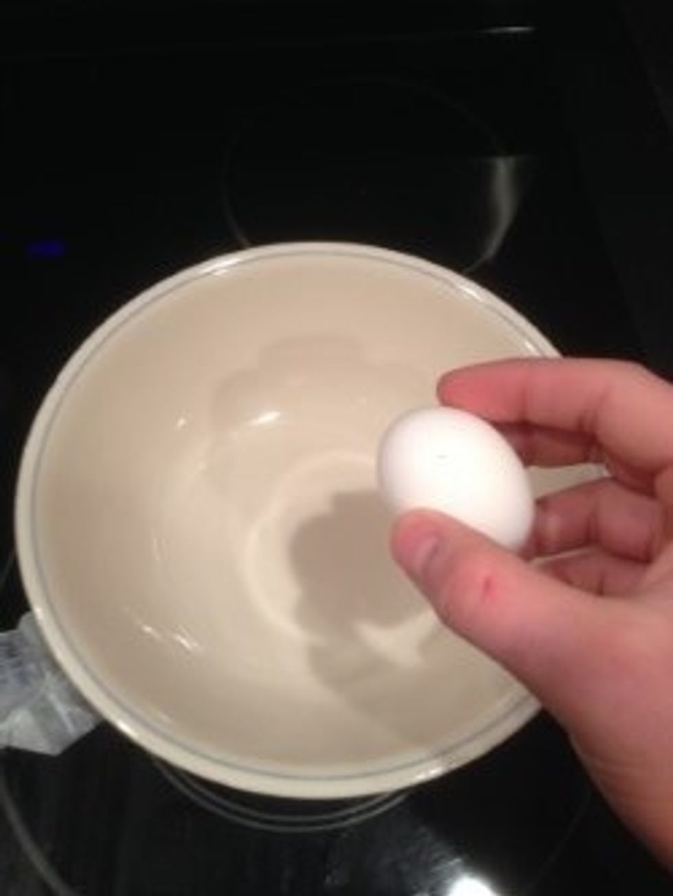 Crack three eggs in a bowl.