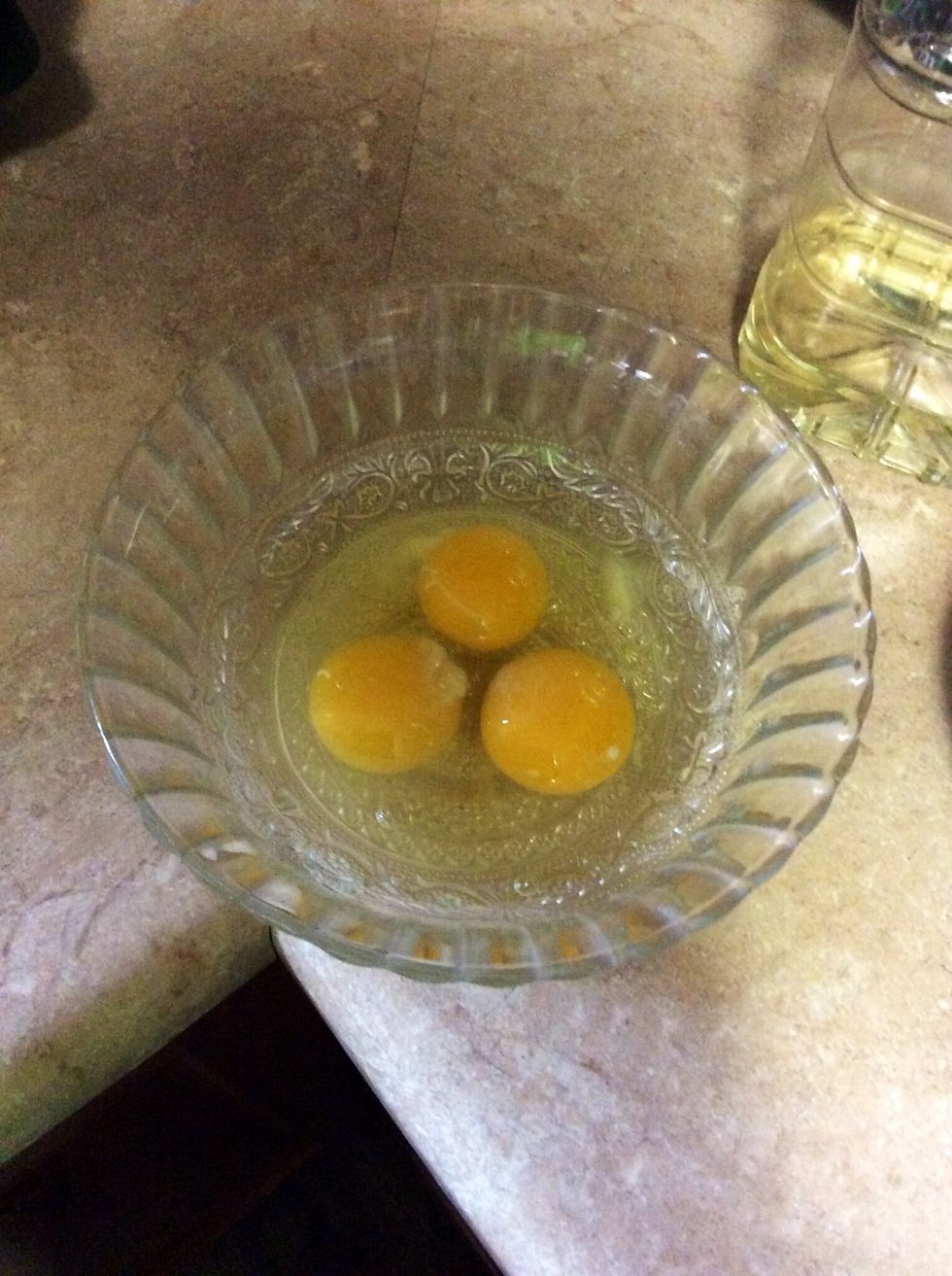Crack three eggs into a bowl