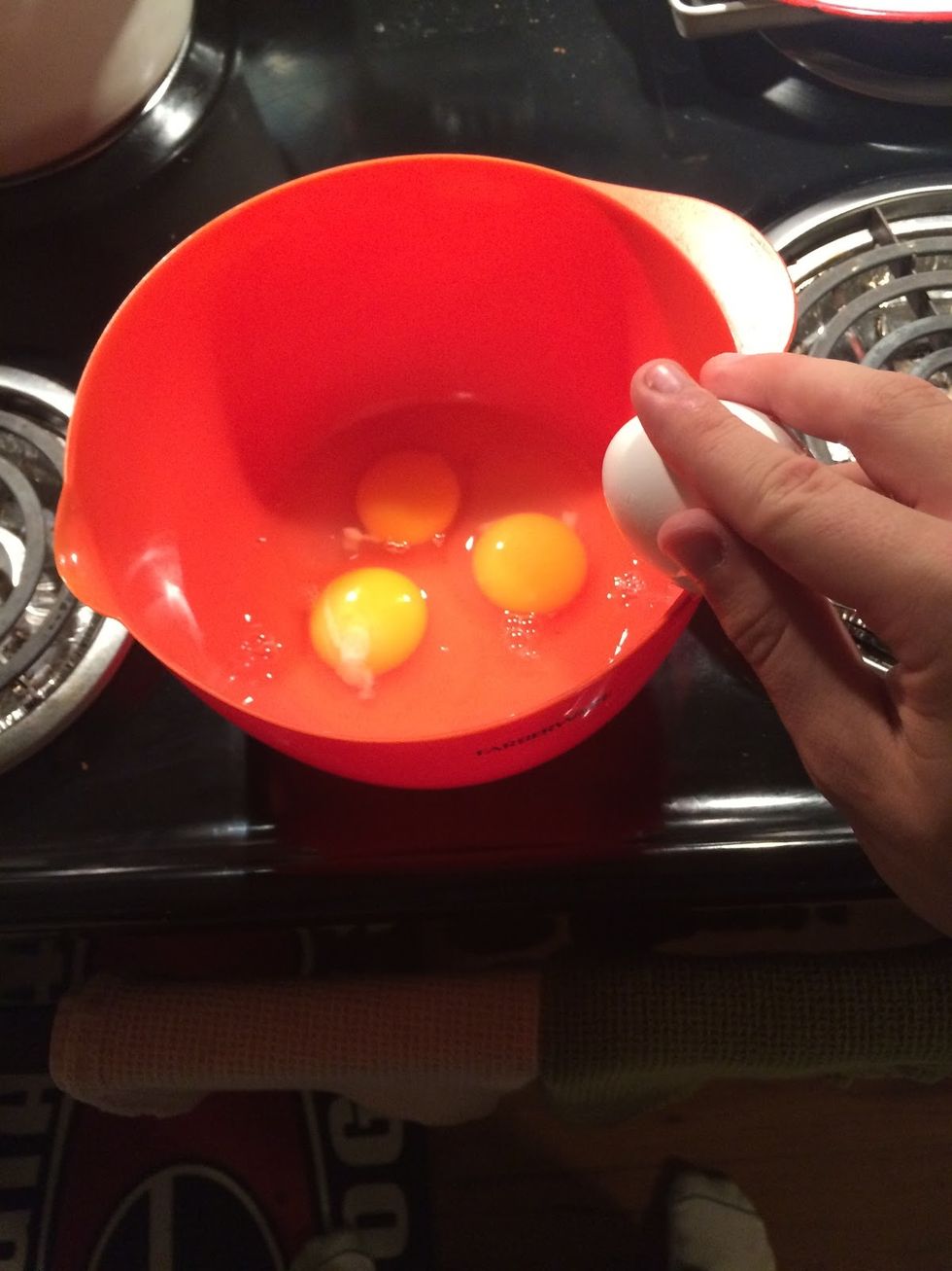 Crack three eggs into a bowl