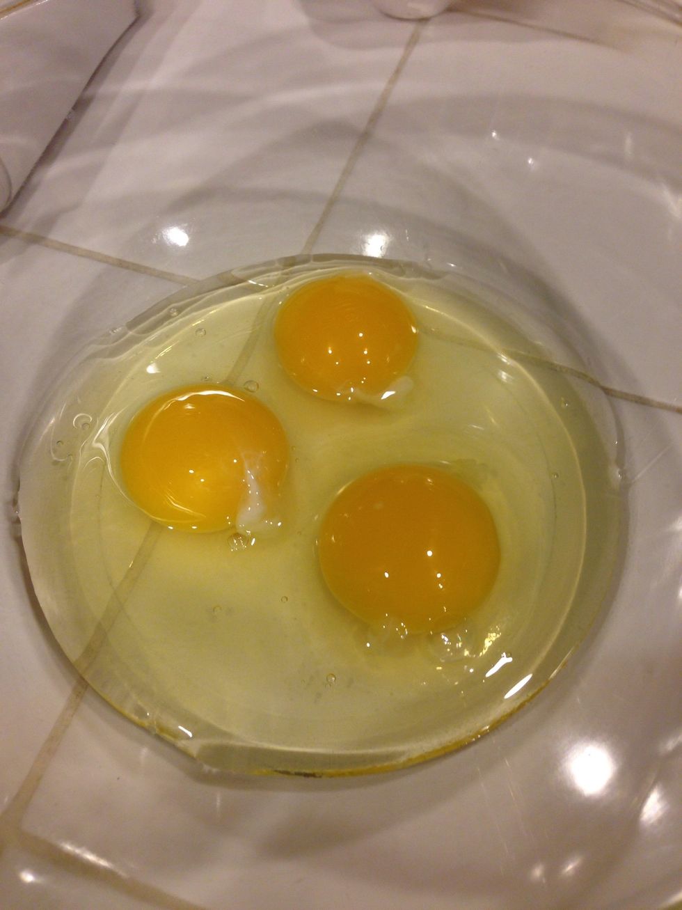 Crack three eggs into a medium bowl