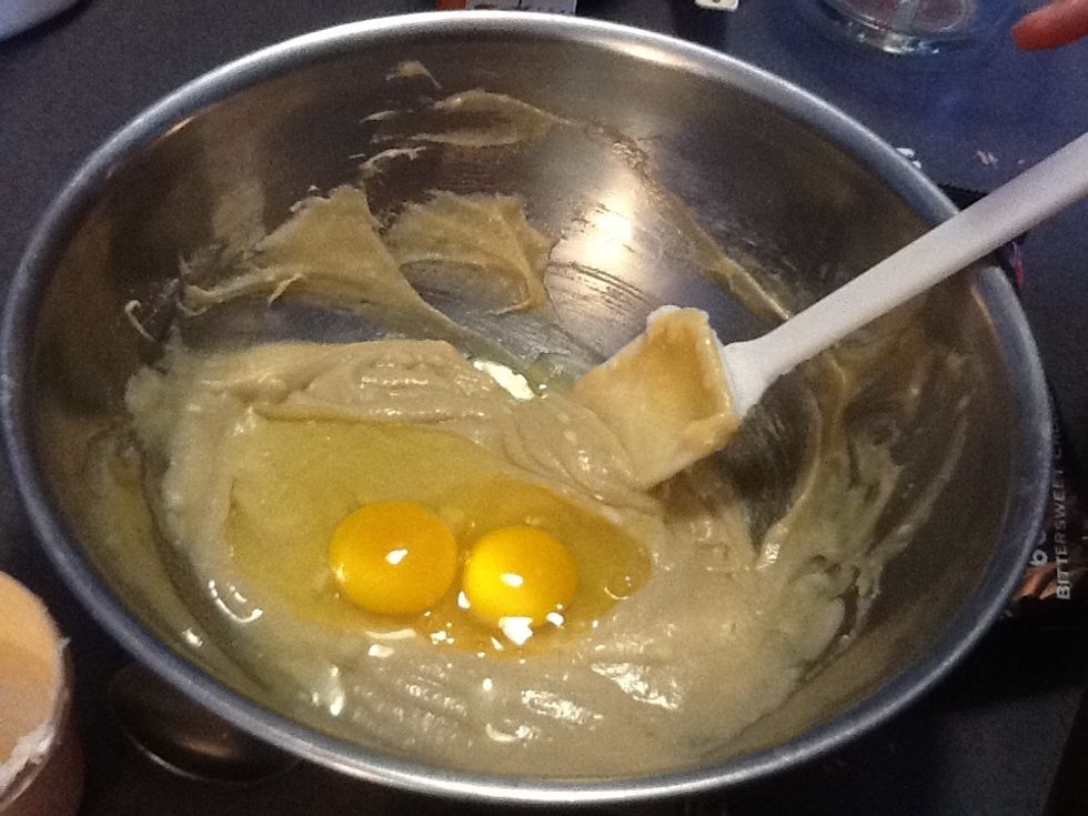 Crack two eggs, and add to mixture. Be careful not to drop in the egg shells. Stir until the eggs have dissolved or disappeared into the mixture.