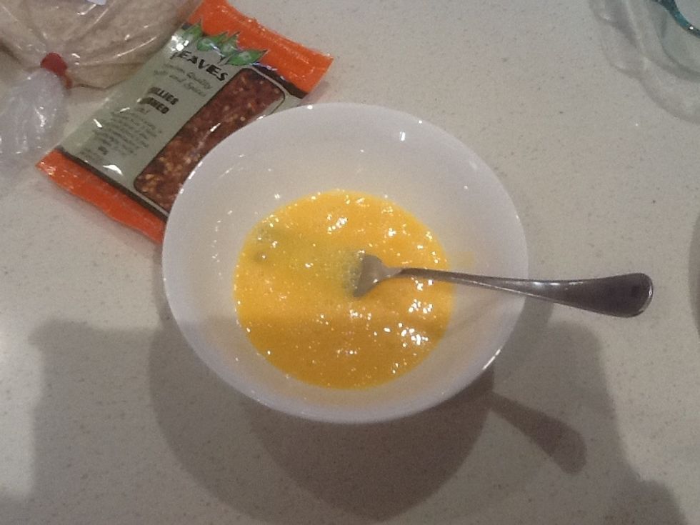 Crack two eggs and whisk until broken down