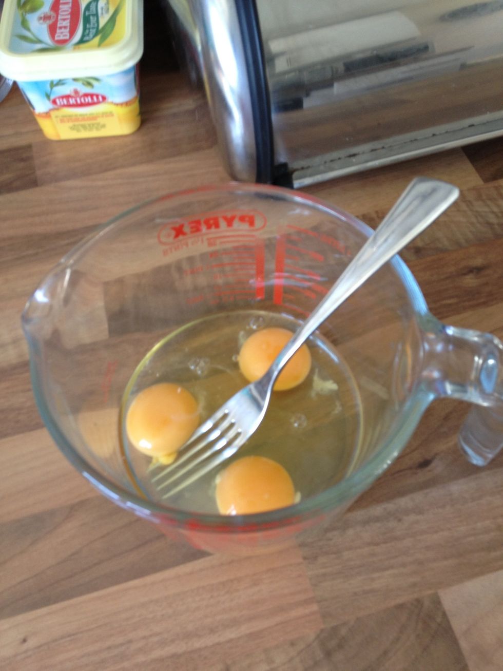 Crack your 3 eggs into a Pyrex jug and whisk with a fork. Season with salt and pepper if desired.