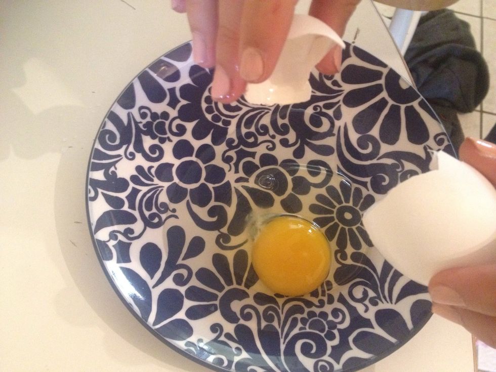 Crack your egg. I'm not talented enough to do it with one hand but if you are, it will make this trick even more impressive.