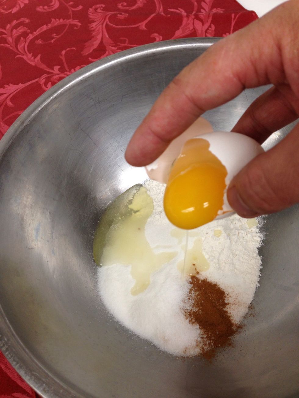 Crack your egg into the mix and combine with your hand.