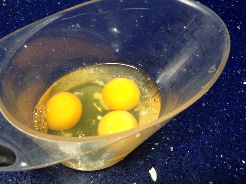 Crack your three large eggs into a separate bowl to make sure no egg shells sneak in the batter.