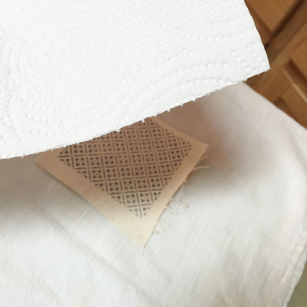 Crafter's Inks are permanent on fabrics when they are heat set. cover ironing board with cloth or paper towels, place stamped fabric piece on it and cover with a white paper towel.