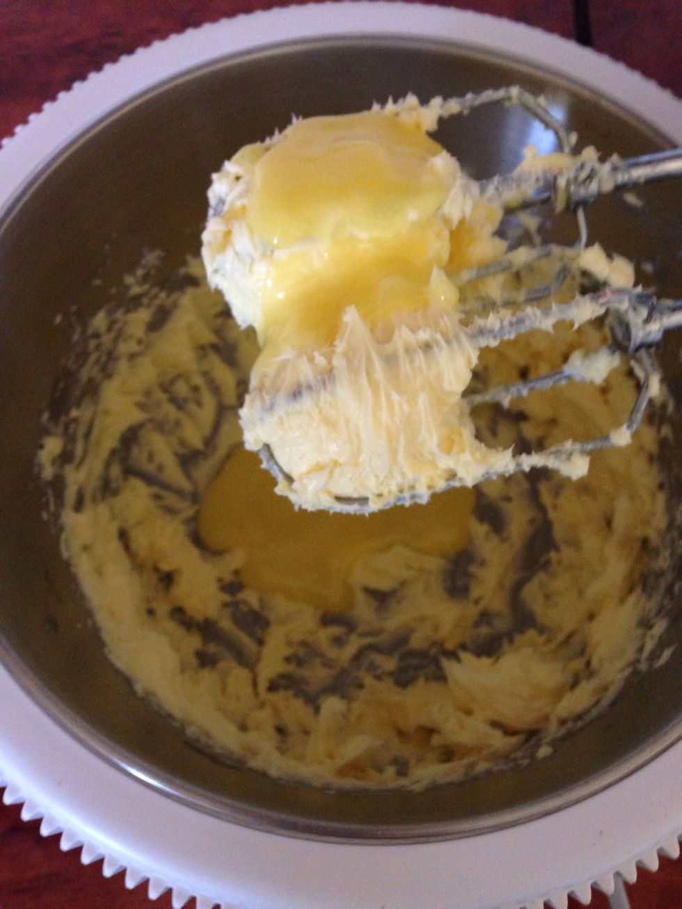 Cream the butter, gradually add the custard and vanilla