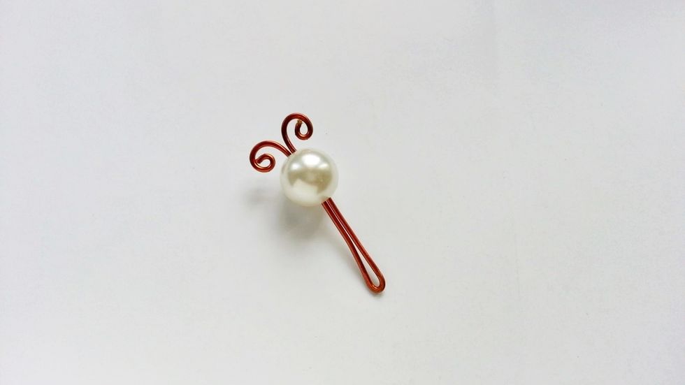 Create 2 swirly shapes to make the antenna of the dragonfly. This will be the body of the dragonfly