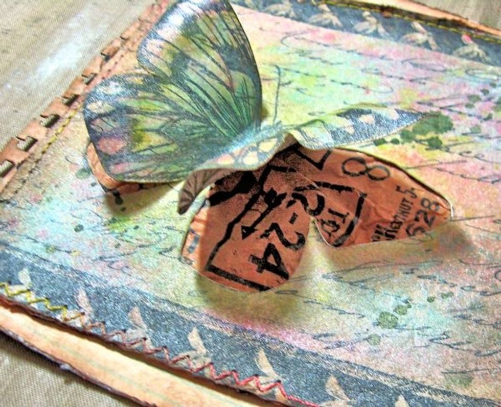 Create a 6" square side fold card base from Kraft Cardstock. Paint the edges with Gold Texture Paste. When dry,  glue the prepared butterfly panel to the card base.  Now add your embellishments.