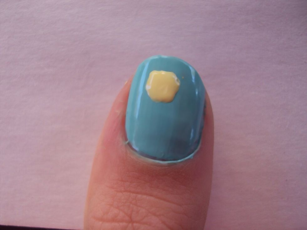 create a big yellow dot on your nail. it doesn't need to be perfect