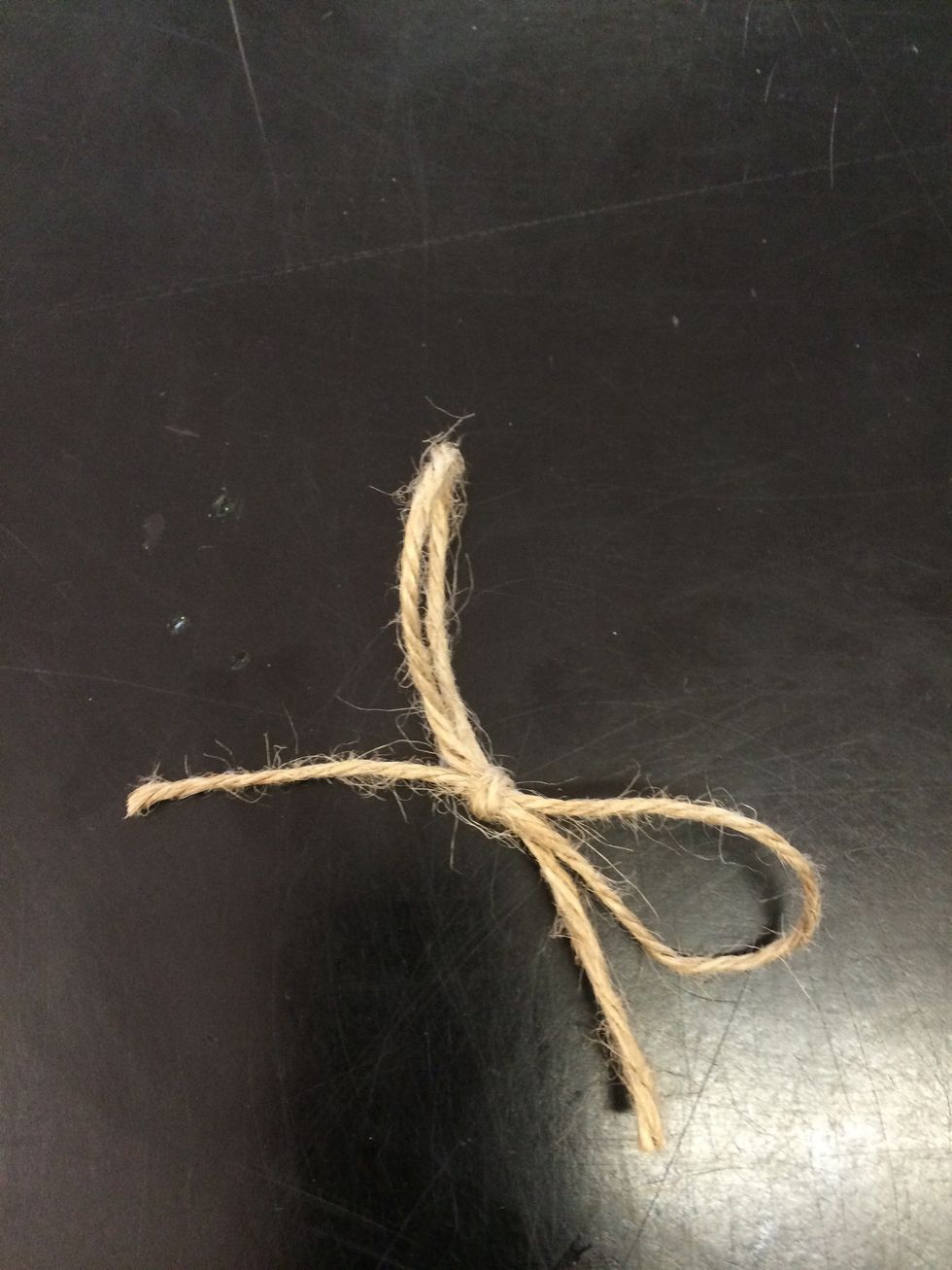 Create a bow from the yarn/string to cover where you glued the yarn/sting on.(optional)