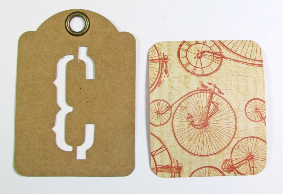 Create a decorative tag using a left-over Alphabet Banner or an Artist Trading Tag. Cut DIY Bicycle paper to slightly smaller than 3" x 2 1/2" and round the corners. Attach the paper to the tag.