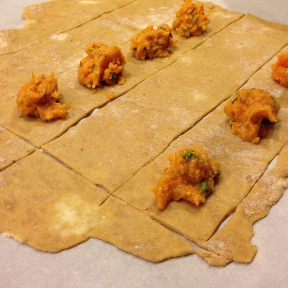 Create a few parallel guidelines about 2 inches apart with a pizza roller. This will help you to dollop 1tbsp of filling in a straight line for next steps.