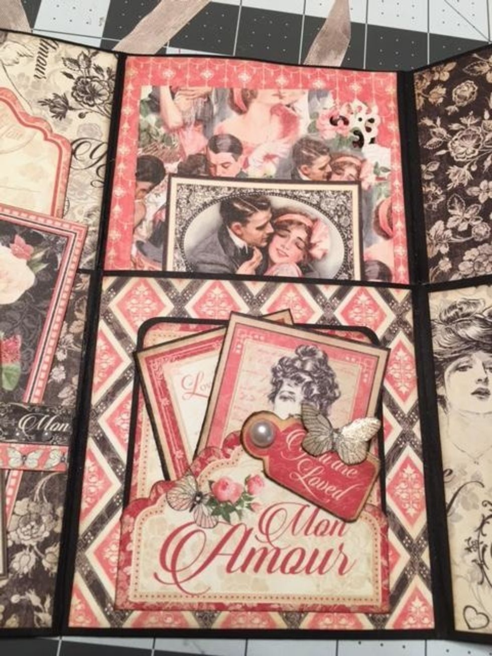 Create a folding photo mat to insert into the pocket by cutting 1 sheet of True Love to 7"wide x 6" tall. Score the 7" side at 3 1/2" and fold in half. Deco punch the corners & add a cut a part image.