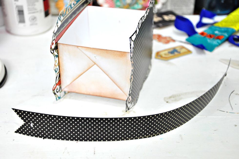 Create a handle by cutting a strip of paper as seen in the image. This is 8 inches x 1 inch.