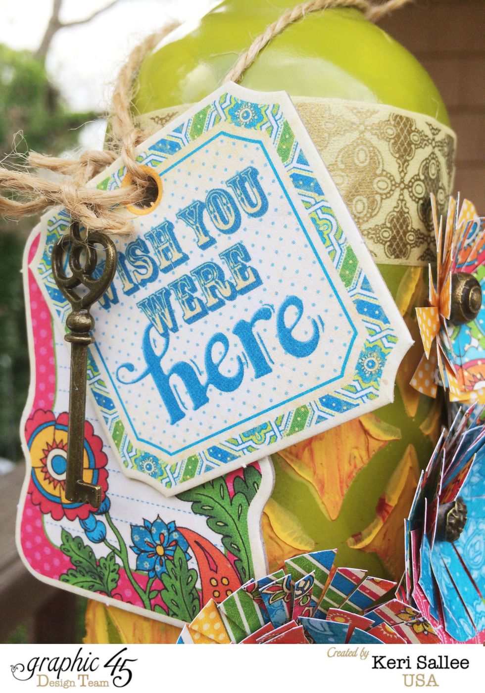 Create a hang tag using 2 tags from the Graphic 45 Chipboard 1 set and tie them and a Graphic 45 Ornate Key using Canvas Corp Hemp. Slide over the top of the bottle.